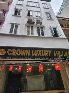 a building with a sign on the front of a store at Crown Luxury Hotel in Hanoi