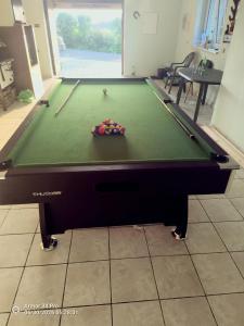 a pool table with balls on top of it at Chatka Mysliwego Wladka in Wola Piotrowa