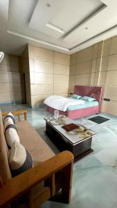a room with two beds and a table in it at devdaar hills homes cafe & resort in Mussoorie +7 photos