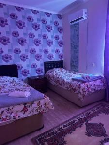 two beds in a room with pink and purple walls at Guest hous Tamuna in Martvili +4 photos