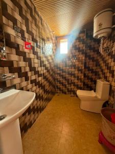 a bathroom with a sink and a toilet at Himalyan Kitchen & Stay in Matiāna
