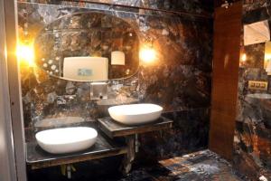 a bathroom with two sinks and a mirror at Pallavi West in Panchkula +17 photos