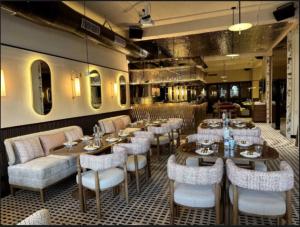 a restaurant with tables and chairs in a room at Pallavi West in Panchkula