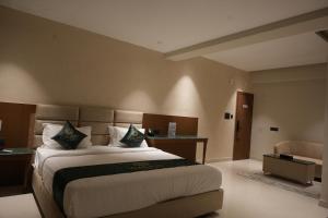 a bedroom with a large bed in a room at Galaxy Air Suites in Bangalore