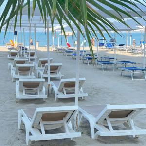 a group of chairs and tables on a beach at Siar Rooms in Durrës