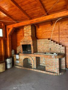 a brick oven in a room with a wooden ceiling at Cabana LUCI - FIGA in Beclean