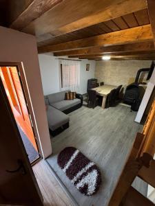 a living room with a couch and a table at Cabana LUCI - FIGA in Beclean