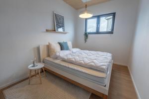 a bed in a room with a small table at Casa CaVi Bergheider See in Buschmühle