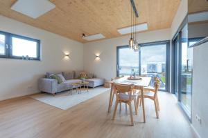 a living room with a table and chairs and a couch at Casa CaVi Bergheider See in Buschmühle