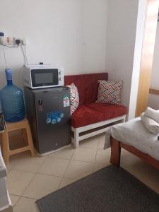 a living room with a red couch and a microwave at Studio solace kitisuru in Nairobi