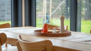 a wooden table with a candle and a strawberry on it at Casa CaVi Bergheider See in Buschmühle +7 photos