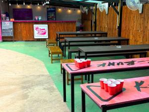 a restaurant with tables with red cups on them at K-Bunk Hostel Pai Walking Street in Pai
