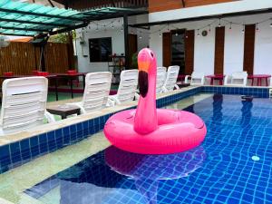 a pink inflatable swan in a swimming pool at K-Bunk Hostel Pai Walking Street in Pai