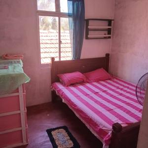 a small bedroom with a bed and a window at Hiru's Place in Gandara East