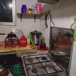 a kitchen with a stove top oven next to a counter at Hiru's Place in Gandara East