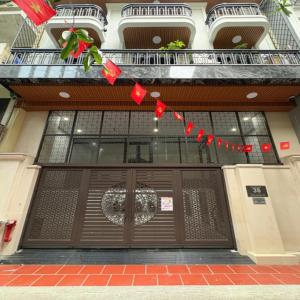 a building with a door with a christmasreath on it at Fuji Apartment in Hanoi