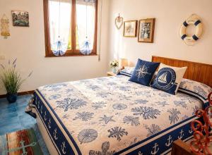 a bedroom with a bed with a blue and white blanket at Sea Horse in Lido di Camaiore