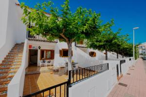 a house with a tree in front of it at Euromar I - TEPINSA Alquiler de Apartamentos in Torreblanca +20 photos