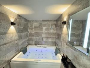 a large bathroom with a tub and a large mirror at Sunrise Villa Lopar in Lopar +70 photos