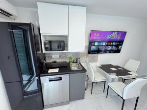 a kitchen with a table and chairs and a counter top at Sunrise Villa Lopar in Lopar