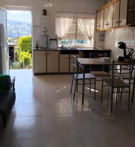 a kitchen with a table and chairs in a room at O Recuncho da Xunqueira in Viveiro