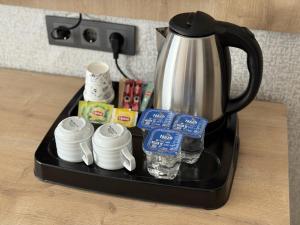 a coffee pot sitting on top of a black tray at Özsoy Otel in Akçay