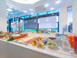 a kitchen with a counter with food on it at Hotel Holland in Rimini