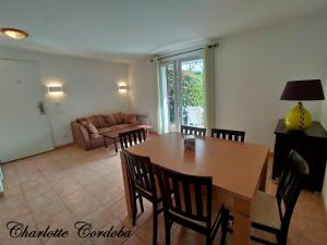 a living room with a table and chairs and a couch at Appartement T3 Barbaste in Barbaste