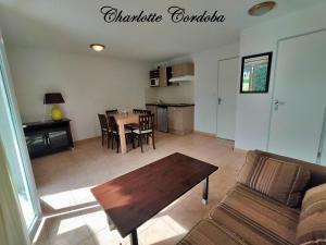 a living room with a table and a couch at Appartement T3 Barbaste in Barbaste +5 photos