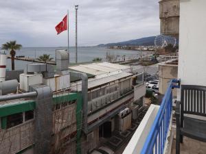 a train sitting on top of a building with a flag at Özsoy Otel in Akçay +11 photos