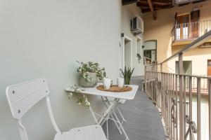 a small table on the balcony of a building at GuestHost - Vivaldi Estate Apartment in Treviglio