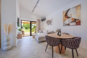 a living room with a table and a couch at House 61 in Milotski Breg +64 photos