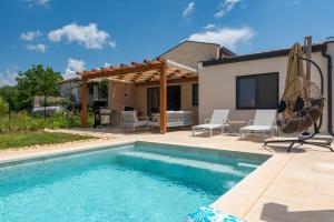 a swimming pool in front of a house at House 61 in Milotski Breg