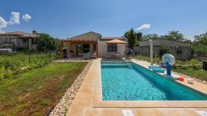 a swimming pool in front of a house at House 61 in Milotski Breg