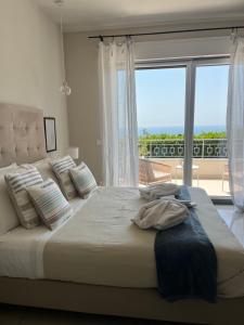 a bedroom with a large bed with a large window at IL MARE BLU in Lerici