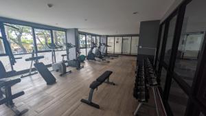 a gym with a bunch of treadmills and machines at Boat Avenue condo in Bang Tao Beach