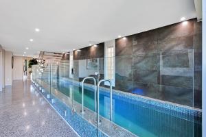 a swimming pool in a building at Lakeside Serenity in Hindmarsh Island