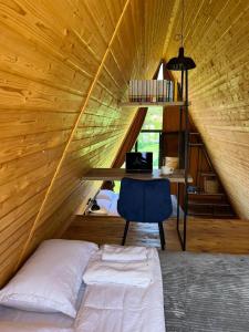 a room with a bed and a desk and a chair at Ja ge • ჟა ღე in Tsalka