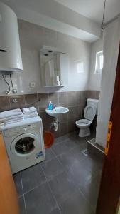 a bathroom with a washing machine and a sink at UnaMar 1 in Prčanj