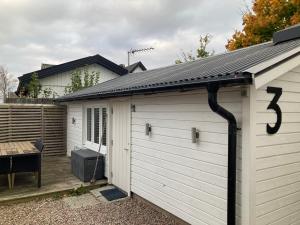a garage with a solar roof on top of it at Compact living Laxvik in a cottage in Halmstad