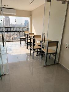 a dining room with a table and chairs and a balcony at Nile View Plaza Hotel in Cairo +14 photos
