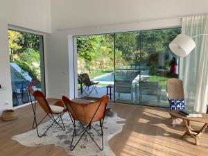 a living room with chairs and a table and glass doors at Villa Prince Garda in Salò