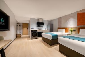 a hotel room with two beds and a tv at Guang Dong Hotel in Guangzhou +30 photos