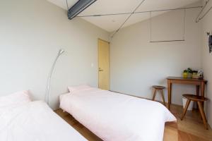 Cama o camas de una habitación en GrapeHouse Koenji
