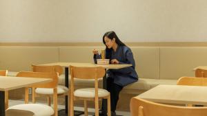 a woman sitting at a table in a restaurant at Anook Hotel & Spa Bucheon Sangdong in Bucheon +214 photos
