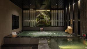 a pool of water in a large room with at Anook Hotel & Spa Bucheon Sangdong in Bucheon