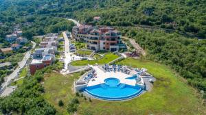 an aerial view of a resort with a swimming pool at Lavender Bay E2-1-studio apartment in Donji Morinj