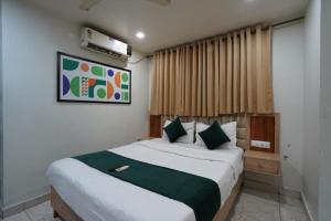 a bedroom with a large bed in a room at Hotel Elmas in Bangalore