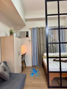 a room with two bunk beds and a desk at Studio and 1 Bedroom Unit at Riri's Condotel, The Loop Tower in Cagayan de Oro +54 photos