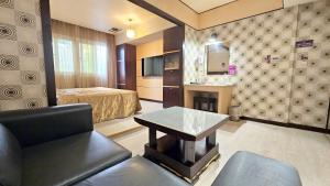 a hotel room with a bed and a table at Beckham Motel in Luzhu